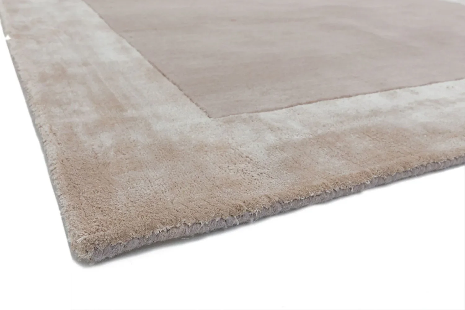 hand tufted carpet with elegant border design and soft plush texture."