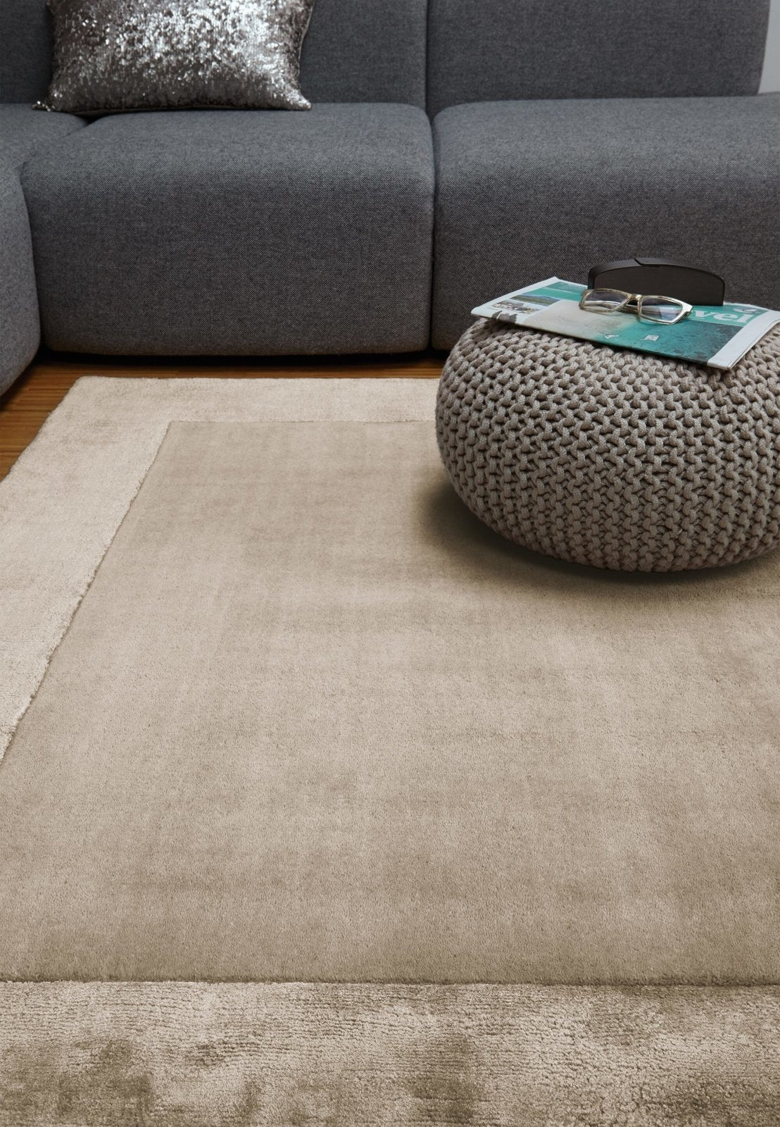 hand tufted carpet with elegant border design and soft plush texture."