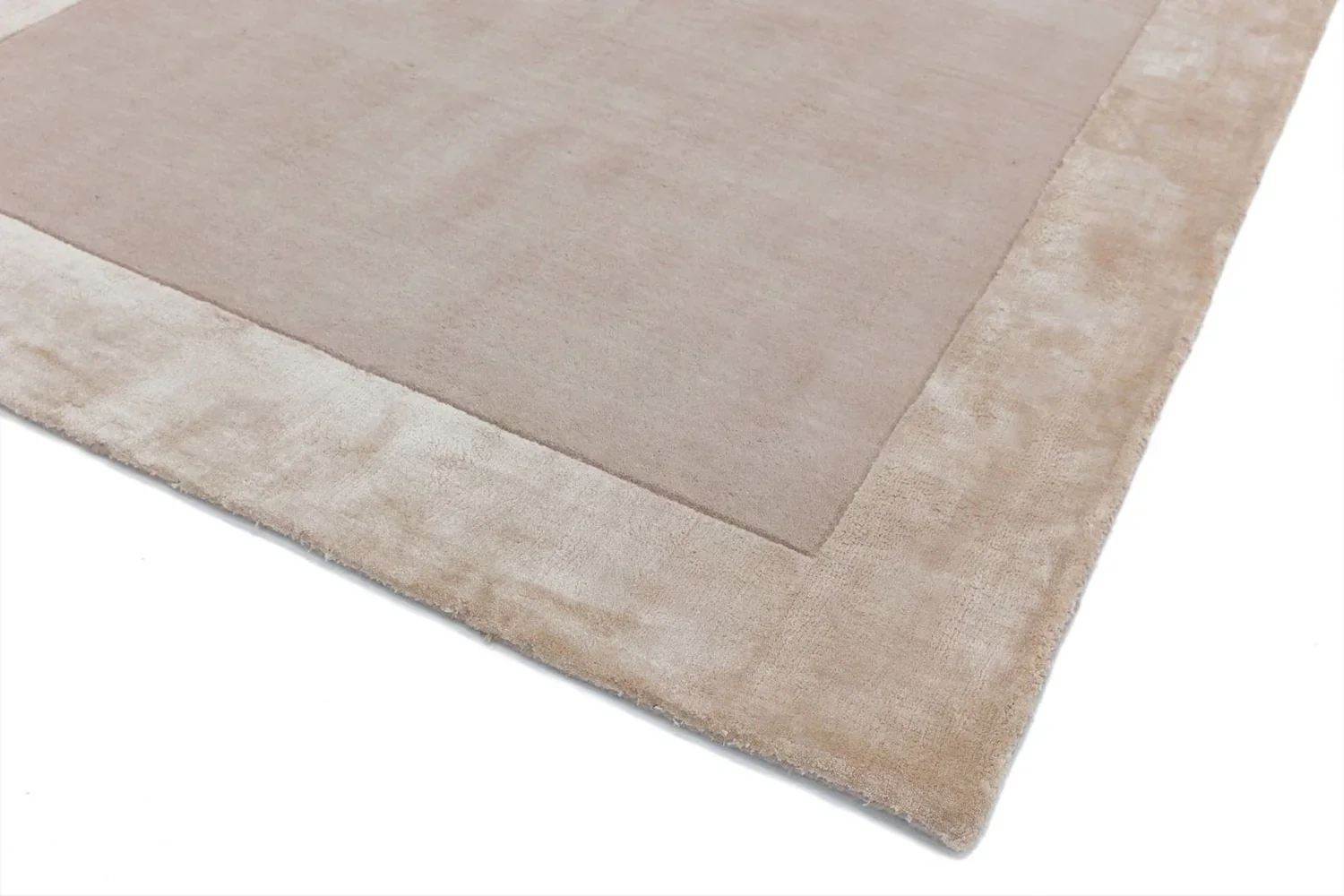 hand tufted carpet with elegant border design and soft plush texture."