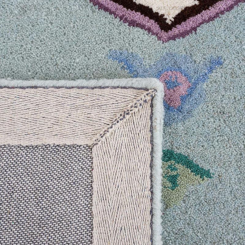 Tufted 6.5 hand tufted carpet with elegant border design and soft plush texture."