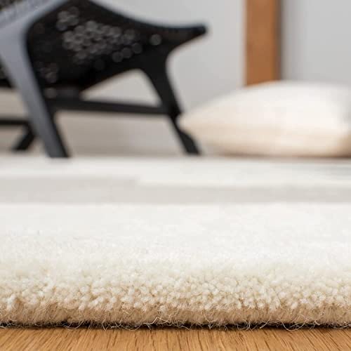 Tufted 9.2 hand tufted carpet with elegant border design and soft plush texture."