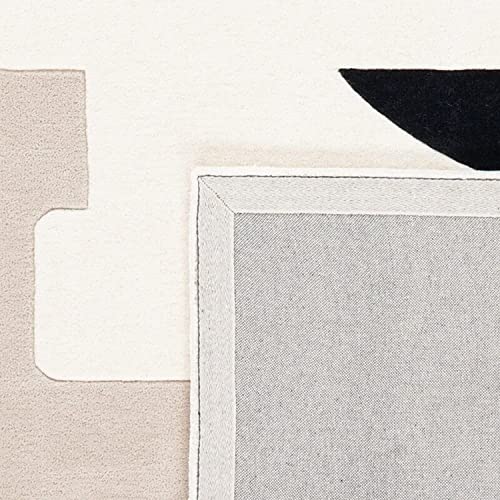 Tufted 9.4 hand tufted carpet with elegant border design and soft plush texture."
