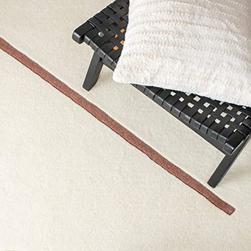 Tufted 9.5 hand tufted carpet with elegant border design and soft plush texture."